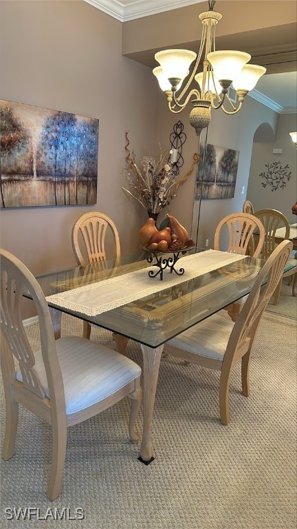 dining room featuring a notable chandelier, arched walkways, crown molding, and carpet flooring