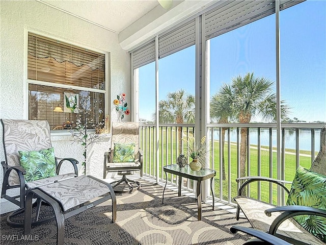 sunroom with a water view and plenty of natural light