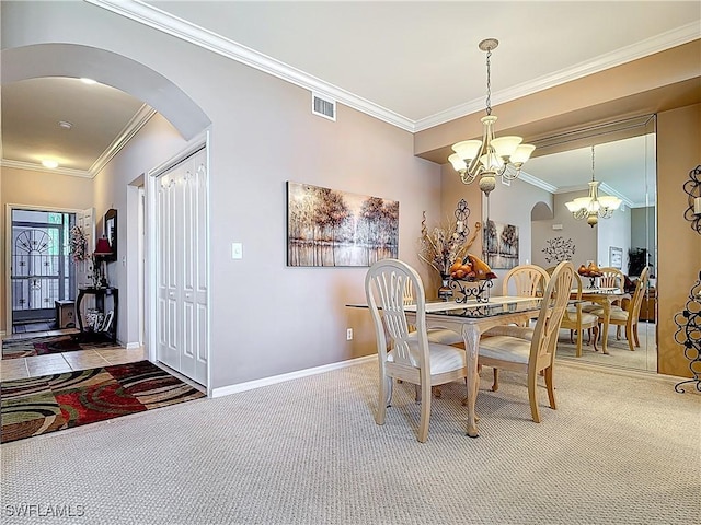 dining room with arched walkways, visible vents, carpet flooring, and a notable chandelier