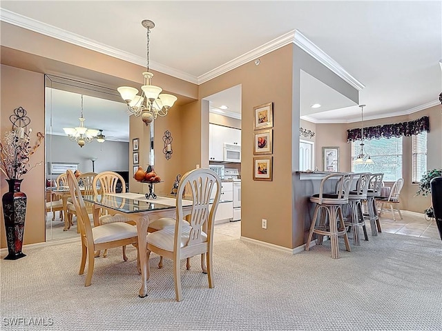 dining space featuring a chandelier, light carpet, baseboards, and ornamental molding