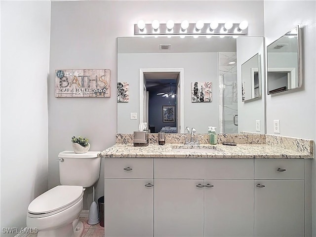 8096 Queen Palm Ln Unit 227, Fort Myers, FL 33966 - bathroom with visible vents, toilet, ensuite bathroom, a shower stall, and vanity