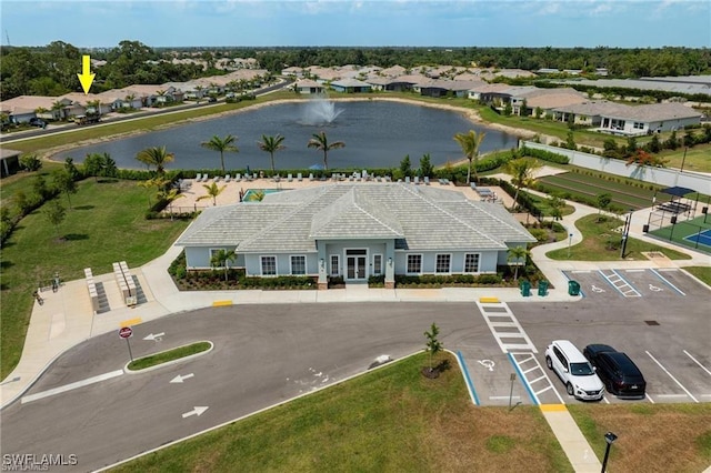 drone / aerial view featuring a water view and a residential view