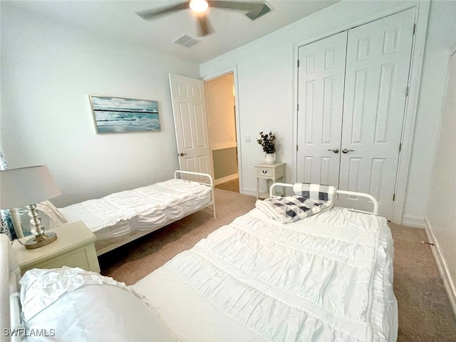 carpeted bedroom featuring ceiling fan, a closet, visible vents, and baseboards