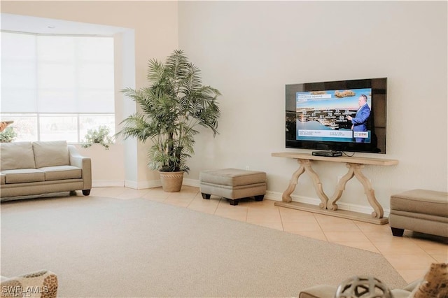 tiled living area with carpet flooring and baseboards