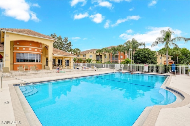 pool featuring a patio and fence