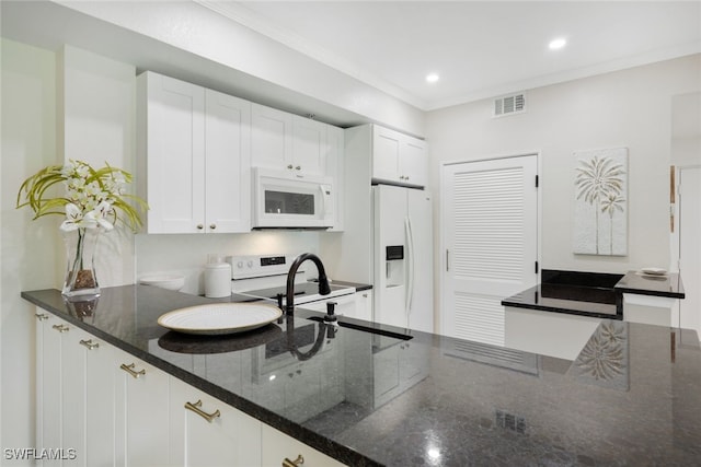 kitchen with white cabinets, white appliances, visible vents, and crown molding