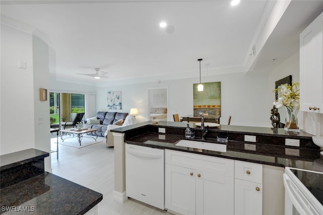 kitchen with white appliances, white cabinets, a sink, and dark stone countertops