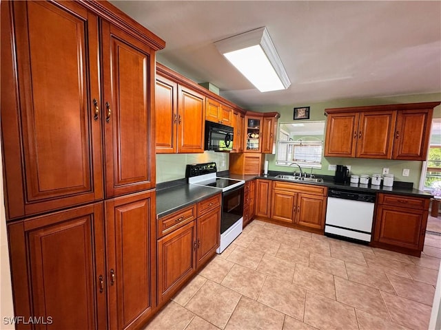 kitchen featuring dark countertops, electric range, a sink, black microwave, and dishwasher