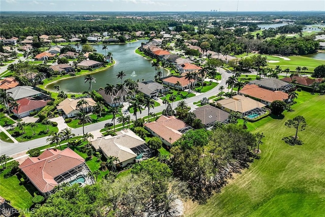 birds eye view of property with golf course view, a water view, and a residential view