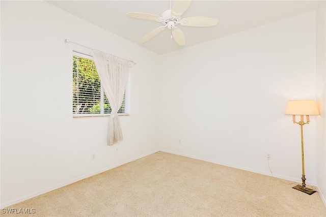 spare room featuring ceiling fan, carpet flooring, and baseboards