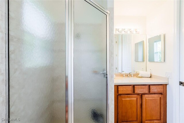 full bathroom featuring a stall shower and vanity