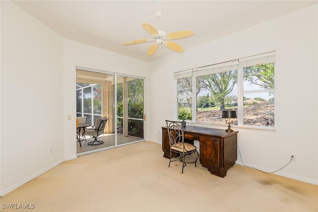 carpeted office featuring ceiling fan and baseboards