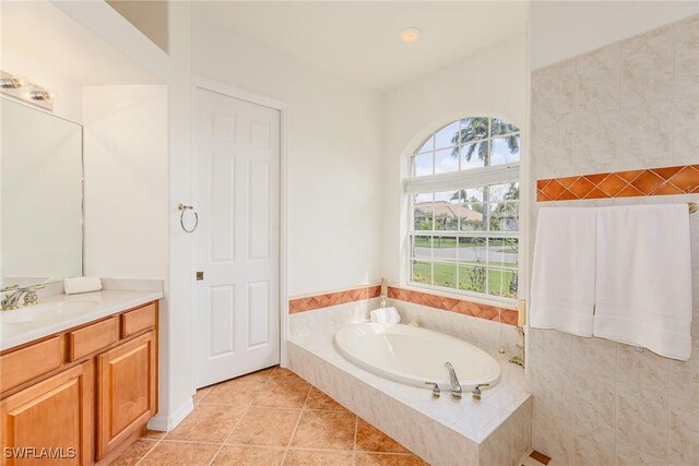 full bathroom featuring a bath, tile patterned flooring, vanity, and a wealth of natural light