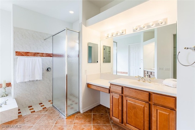 bathroom with a garden tub, tile patterned flooring, a tile shower, and vanity