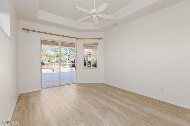 8880 Lely Island Cir, Naples, FL 34113 - unfurnished room with baseboards, light wood-style flooring, a ceiling fan, and a raised ceiling