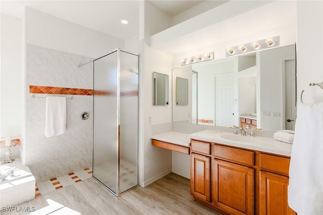 8880 Lely Island Cir, Naples, FL 34113 - full bathroom with vanity, wood finished floors, and walk in shower