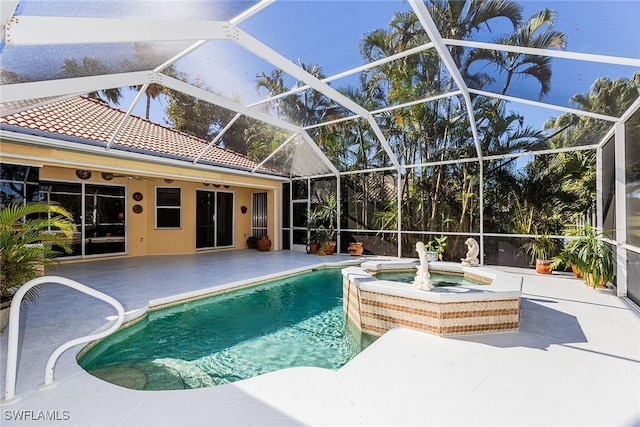 8880 Lely Island Cir, Naples, FL 34113 - view of swimming pool with glass enclosure, a pool with connected hot tub, and a patio area