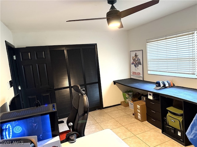 office featuring light tile patterned flooring, ceiling fan, and baseboards