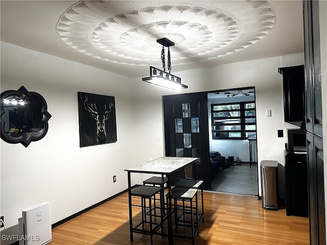 dining room with baseboards and light wood finished floors