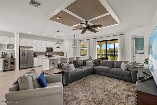 living area featuring visible vents, a ceiling fan, wine cooler, crown molding, and recessed lighting