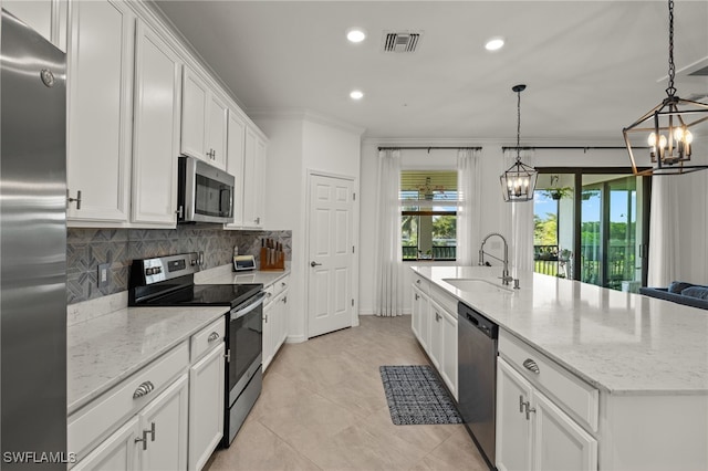 kitchen featuring visible vents, white cabinets, decorative backsplash, stainless steel appliances, and a sink