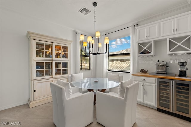 dining space featuring light tile patterned floors, beverage cooler, visible vents, a bar, and a chandelier