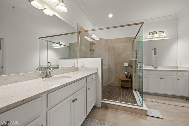 bathroom featuring a shower stall, two vanities, a sink, and crown molding