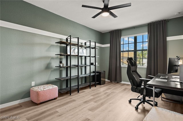 office space with wood finished floors, a ceiling fan, and baseboards