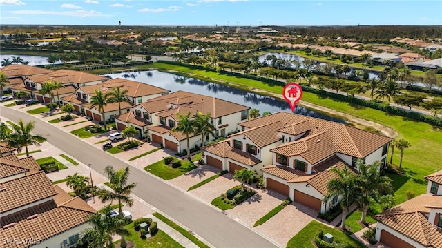 birds eye view of property with a water view and a residential view