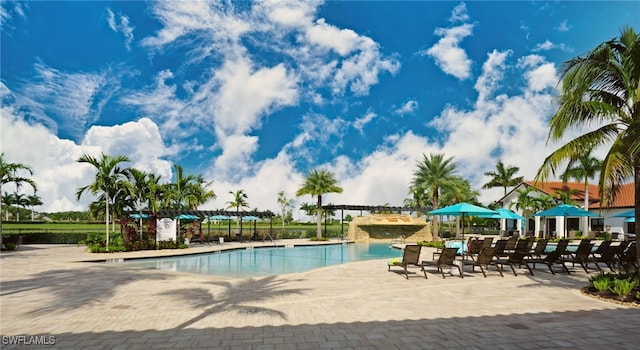 community pool featuring a pergola and a patio