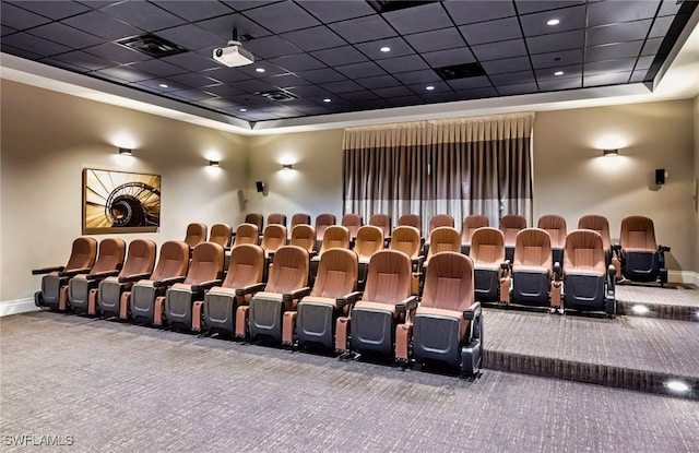 home theater room with baseboards, visible vents, a raised ceiling, a drop ceiling, and carpet floors