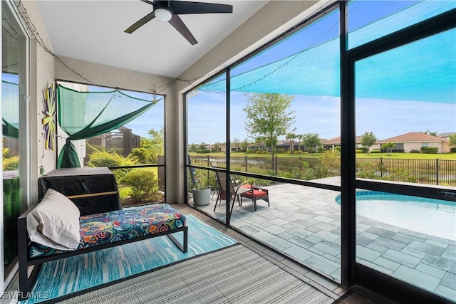 sunroom featuring a ceiling fan