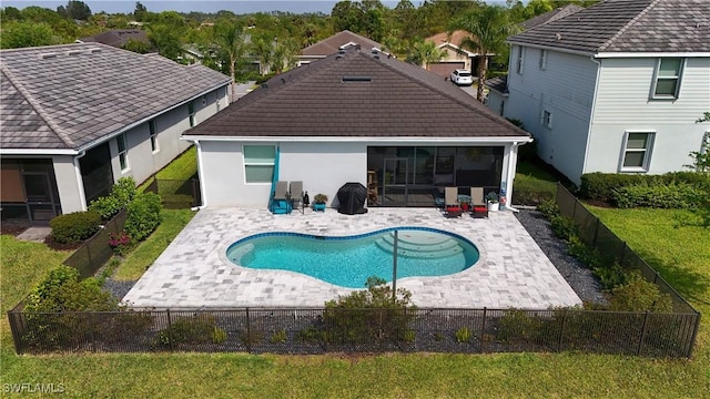 view of pool with a fenced backyard, a fenced in pool, a sunroom, and a patio area