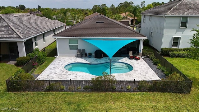 view of swimming pool with a yard, a fenced backyard, and a patio area