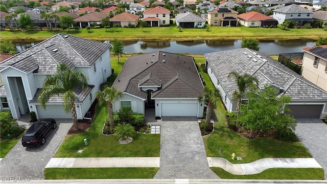 birds eye view of property with a residential view and a water view