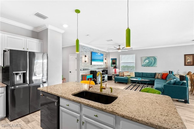 kitchen with ornamental molding, a sink, open floor plan, refrigerator with ice dispenser, and dishwasher