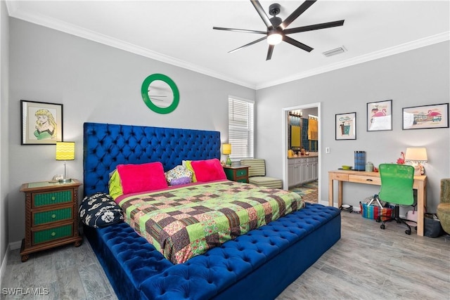 bedroom with crown molding, connected bathroom, baseboards, wood finished floors, and visible vents