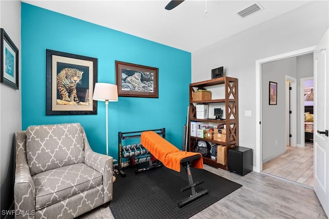 sitting room featuring baseboards, ceiling fan, wood finished floors, and visible vents