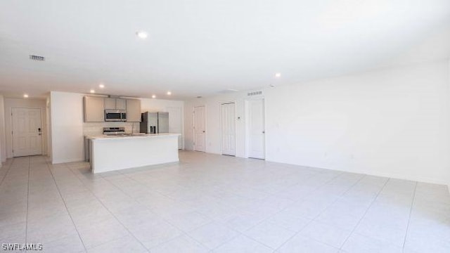 unfurnished living room featuring visible vents and recessed lighting