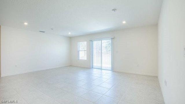 empty room with recessed lighting and baseboards