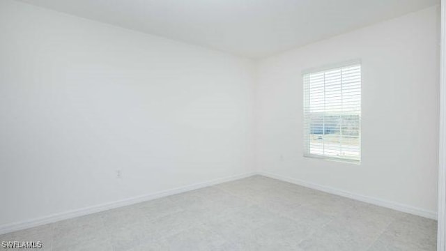 unfurnished room featuring baseboards