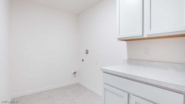 washroom with hookup for a washing machine, cabinet space, baseboards, and electric dryer hookup