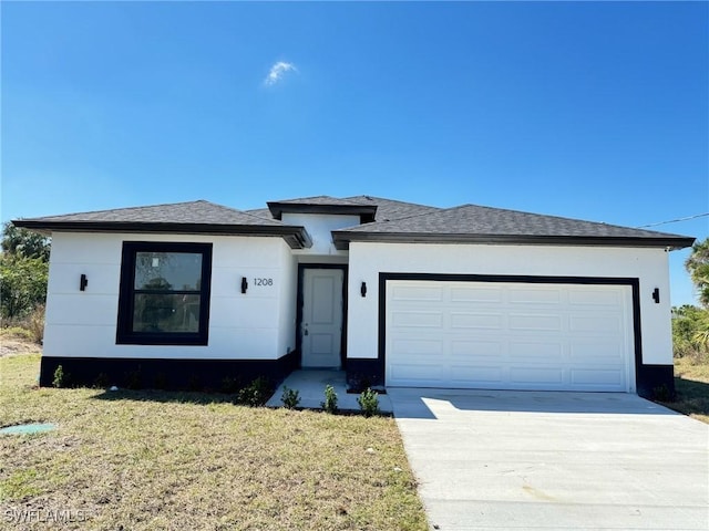 view of front of house featuring driveway, a front yard, an attached garage, and stucco siding