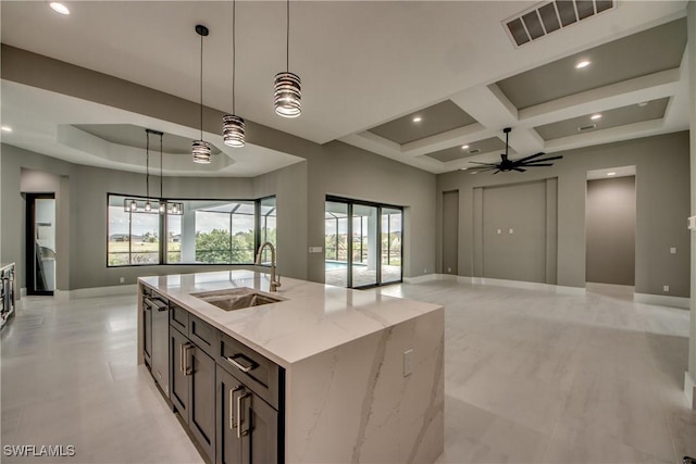 kitchen featuring visible vents, coffered ceiling, elevator, ceiling fan, and a sink