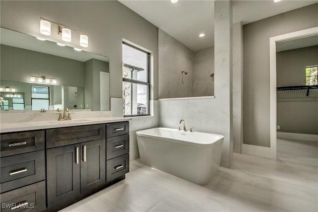 full bath featuring a soaking tub, a shower, and vanity