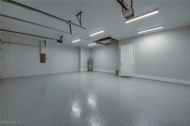 garage featuring a garage door opener, electric panel, baseboards, and electric water heater