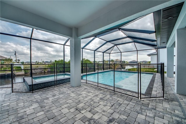 pool featuring glass enclosure and a patio