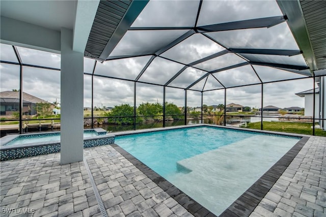 view of pool with a patio area, a lanai, and a pool with connected hot tub