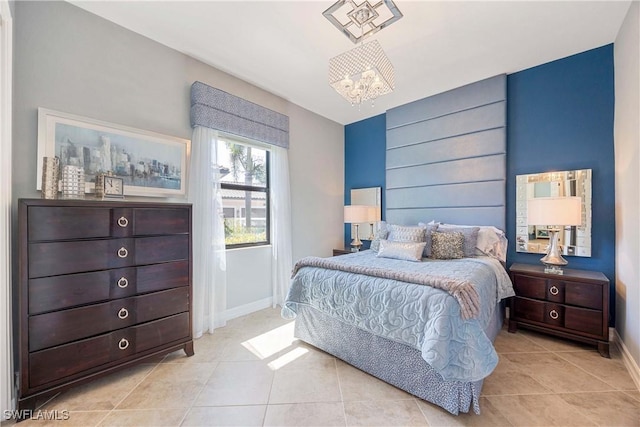 bedroom with light tile patterned floors, baseboards, and an inviting chandelier