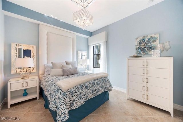 bedroom featuring a chandelier, baseboards, and tile patterned floors